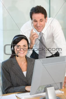 Two businesspeople using computer