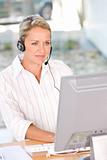 Face of young charming confident business woman with headset