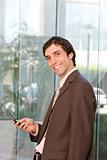 portrait of confident smiling business man holding cell phone