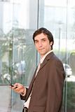 portrait of confident business man holding cell phone