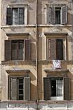 six windows with laundry and shutters in rome