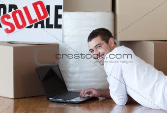 Man using a laptop on floor
