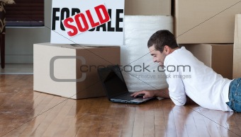 Man using a laptop on floor
