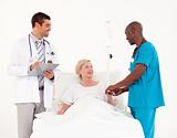 Doctors at patients bedside