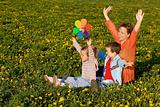 Spring sun worshipers - woman with kids on the flower field