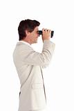Businessman looking through a binoculars