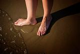 barefoot legs on the sand beach