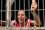 woman behind bars crying