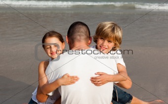 Children hugging their father
