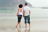 young Couple holding hands on the beach