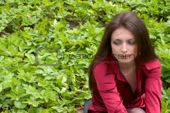 spiing portrait of sexy brunette on the green foliage