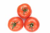 Three red tomatoes lay on a white background