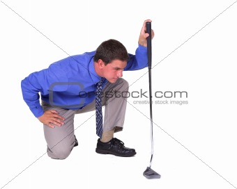 Man with blue shirt aiming over putter 