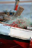 Red dhow sailing boat with nets
