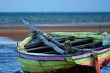 Pink Yellow Sailing boat stranded at low tide in ocean Mozambiqu