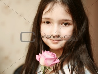 The lovely sight of the girl which holds a pink rose in a hand