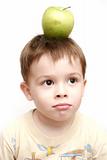 The boy with a green apple on a head