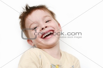 The happy boy is dared laying on a white background