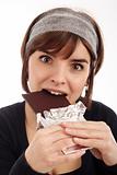 Pretty young woman eating chocolate