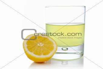 Half and glass of fresh lemon juice