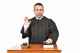 Serious male judge taking oath