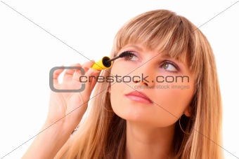 Young woman make up her eyelash isolated on white
