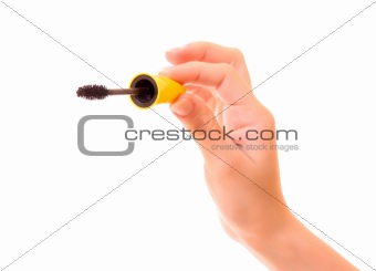 Black mascara in hand isolated on white