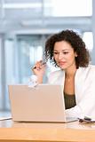 Attractive business woman working on laptop