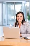 Attractive business woman working on laptop