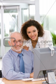 Confident business team working on computer
