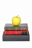 Yellow apple on old books