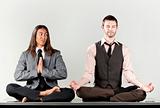 Two businessmen meditating