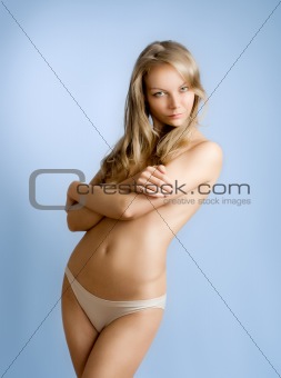 Studio shot of a beautiful young woman covering herself 