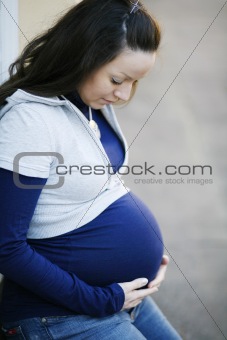 Young pregnant women outdoors.