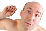 man with funny look using a q-tip