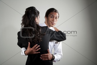Mixed race professional man embracing Hispanic woman