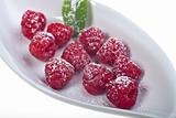 raspberries with icing sugar on a plate