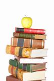 Yellow apple on pile of books