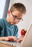 Computer kid. Eating apple
