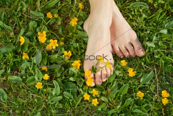 Woman resting her feet in the fresh spring vegetation