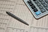 Professional calculator, steel pen and financial newspaper. Business concept.