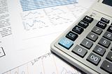 Calculator and financial data with graphs. Business concept.