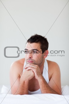 Attractive man lying in bed