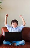 Happy child playing with his laptop