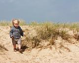 little boy on sand dunes