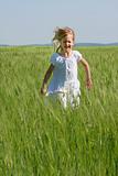cute girl running in green grass