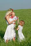 happy mother with two children in traditional clothes outdoors