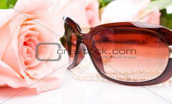 Pink rose, necklace and sunglasses