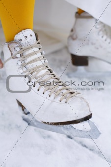 Close-up of an ice skate on a female foot.