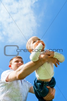 Baby flying on father's hands